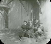 [Outing in the country, group portrait with Catharine Rupp Doering sitting on steps of unidentified building.]