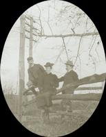 [Outing in the country, siblings of William Doering sitting on fence.]