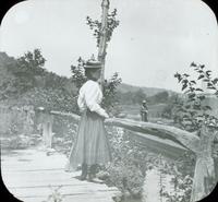 [Catharine Rupp Doering standing on a canal bridge.]