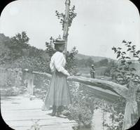 [Catharine Rupp Doering standing on a canal bridge.]