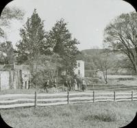 [Bicycling trip, group with Catharine Rupp Doering stopped in front of an old farm.]
