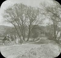 [Bicycling trip, group with Catharine Rupp Doering stopped on dirt road.]