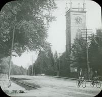 [William and Karl Doering bicycling past St. Paul's Episcopal Church, Old York Road and Ashbourn Avenue, Elkins Park, Pa.]