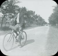 [William Doering on bicycle.]