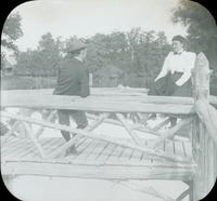 [Couple on rustic bridge over a canal, Long Island, N.Y.]