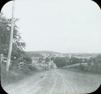 [Landscape view of country road from top of hill.]