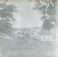 [Rear view of dwellings from a hill.]