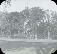 [Distant view of church surrounded by park.]