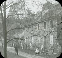 [Man and two girls in front of the old Livezey mill on the Wissahickon Creek, Philadelphia.]