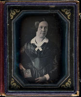 [Julianna Randolph Wood in a dark dress, holding a daguerreotype portrait of a Richard D. Wood in her right hand.]