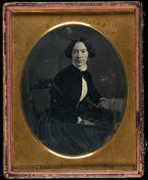 [Portrait of an unidentified, seated young woman, wearing a black dress with a white bodice.]
