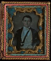 [Portrait of an unidentified, young man wearing a white tie, with a black, leather strap across his chest.]