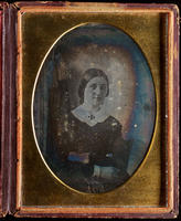 [Portrait of an unidentified young woman, long hair, parted in the middle, wearing a white collar with a black brooch.]