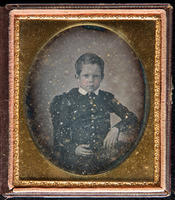[Portrait of an unidentified boy with his left arm is resting on a table.]