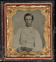 [Portrait of a seated, unidentified, young man wearing a white shirt and a tie.]