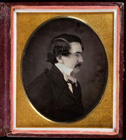 [Unidentified man with mustache, in profile with high white collar and cravat.]