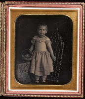 [E.O. Craven as a child, holding a basket of flowers.]