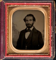 [Portrait of an unidentified man with beard and mustache wearing a medal in the shape of a Maltese Cross.]