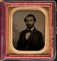 [Portrait of an unidentified man with beard and mustache wearing a medal in the shape of a Maltese Cross.]