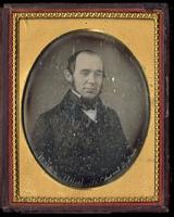 [Portrait of a balding man with sideburns.]