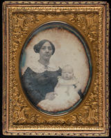 [Mrs. William George Spencer holding her baby Warren Otis Spencer on her lap.]