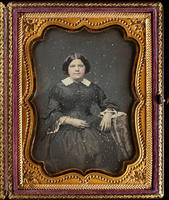 [Three quarter length portrait of a seated, unidentified young woman, hair parted in middle, wearing dress with lace collar and cuffs.]
