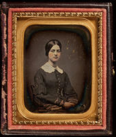 [Portrait of a prim, unsmiling, unidentified young woman wearing a white lace collar.]
