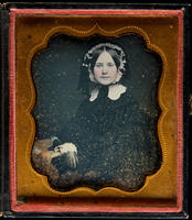 [Portrait of an unidentified, young woman, wearing a white lace cap, her right arm is resting on a table. ]