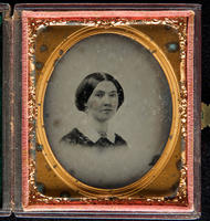 [Vignette portrait of an unidentified woman, hair parted in the middle, wearing a brooch.]