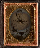 [Portrait of a seated, unidentified young man, hands resting in his lap.]