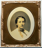 [Portrait of an unidentified young woman, hair parted in the middle, wearing a white blouse with a black satin bow at the neck.]